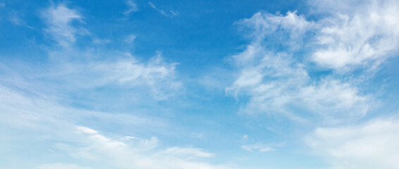Wall Mural - sky is blue and clear with clouds. The sun is shining brightly, making the sky look even brighter. Scene is peaceful and serene