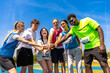 © unai - Young athletes joining hands before track and field competition