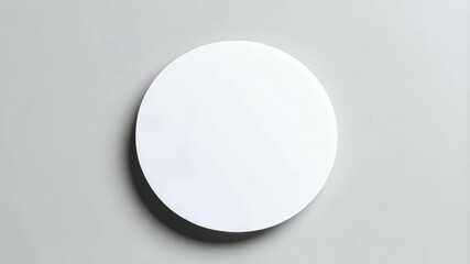 Poster - Minimalist white round shape rotating slowly against a solid gray background. Studio shot showing smooth circular movement and subtle shading.