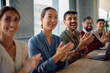 © Drazen - Happy colleagues applauding after successful business meeting in office.