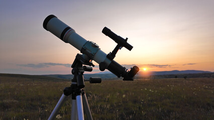 Wall Mural - Preparing for night sky observing with a astronomical telescope just before sunset in the countryside.
