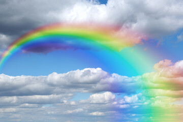 Wall Mural - bright rainbow in blue sky with clouds on sunny day