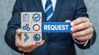 © mediastok.ai - Businessman holding wooden blocks with a request displayed.