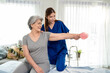 © Kawee - Asian senior mature woman doing physiotherapist with support from nurse.