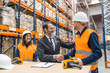 © Koldo_Studio - Manager shaking hands with a worker in a logistics warehouse, finalizing a successful business deal