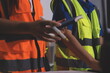 © Sirikarn Rinruesee - Closeup of team of industrial engineers meeting analyze machinery blueprints consult project on table in manufacturing factory. Working in manufacturing plant or production plant.