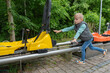 © Elena - Child Enjoying a Fun Ride on a Yellow Pedal Cart