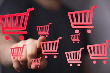 Aufkleber - Person interacts with digital shopping carts, symbolizing online shopping, e-commerce, and digital purchasing.