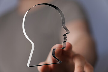 Leinwandbilder - Hand reaching out to select a translucent head profile, symbolizing choice and identity.