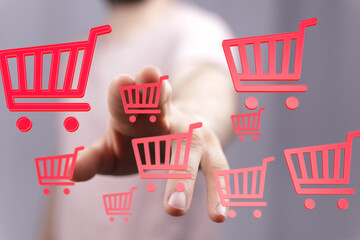 Aufkleber - Person interacts with digital shopping carts, adding items to online order.