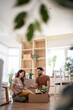 © Migma_Agency - Happy couple unpacking boxes in new home after moving house