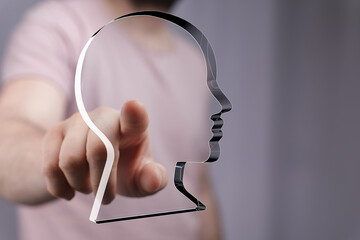 Aufkleber - Hand points at a transparent head profile, symbolizing digital identity, AI, or personal data.
