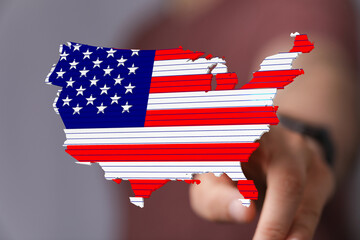 Poster - Stock photo of a hand interacting with a 3D map of the USA designed with the American flag.