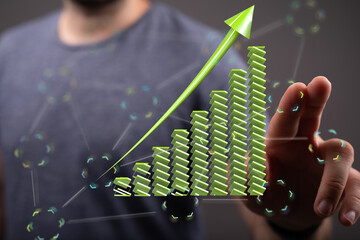 Poster - Stock photo of a hand interacting with a 3D green upward growth chart, symbolizing financial success and business growth.