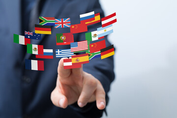 Aufkleber - Image of a hand interacting with flags of various countries, symbolizing global business and international trade.