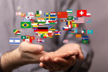 Aufkleber - Image of hands holding various flags, symbolizing global connection and international collaboration.