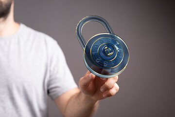 Poster - Image of a man holding a digital combination lock, representing cybersecurity and data protection.