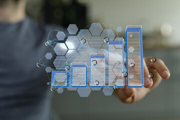 Poster - Stock photo of hand interacting with a digital bar chart, representing data analysis and business growth visualization.