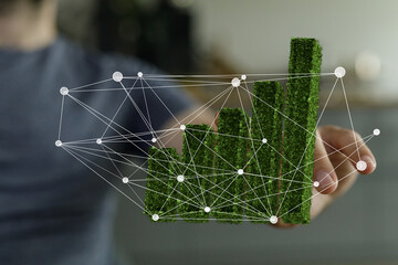 Poster - Image of a person interacting with a 3D graph representing sustainable growth and environmental responsibility.