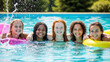© Shootdiem - Group of happy teenage girls enjoying a sunny day in a blue outdoor pool with colorful floats, laughter, and friendship all around.