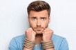© Gatherina - Caucasian man with tied hands expressing frustration
