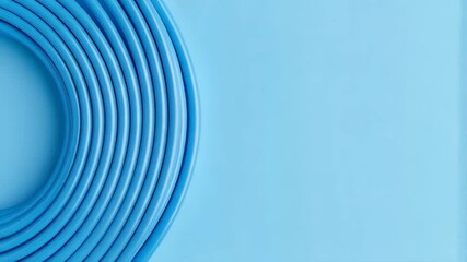Poster - Bright blue flexible plastic tubing coiled on a solid light blue backdrop, forming a minimalist abstract composition with smooth curves, conveying connectivity and fluidity.