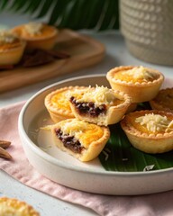 Poster - Cheese topped tartlets with chocolate filling on a plate with banana leaf
