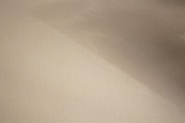 Template concept with leather texture effect in beige color and diffused light in the form of diagonal shadows for presentation of natural products.  Easily editable background for overlaying light.