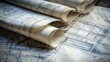 © Stanislau - Architectural blueprints rolled on table showcasing detailed plans for construction projects and designs
