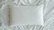 © Sonita - Overhead shot of white pillow and bedsheet set