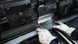 © Iryna - Worker operating industrial press brake to bend metal sheet. A person wearing protective gloves is using a press brake machine to accurately bend a flat sheet of metal.