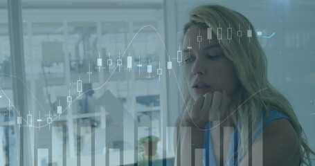 Poster - Woman analyst wearing sleeveless blouse studying digital charts at office desk, copy space