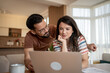 © Migma_Agency - Couple managing finances at home using laptop: concentrated young couple reviewing domestic budget on laptop in living room