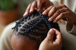 © miss irine - Close-up shows expert hands braiding little girl hair. Creating afro braids hairstyle. Pro hairstylist, creating intricate coiffure. Beauty, care, fashion, style. Black hair art.