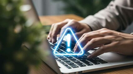Poster - Close up of hands typing on laptop keyboard with blue warning sign overlayed on the screen view