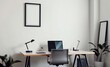 © Creative Canvas - A minimalist haven where a sleek black mock-up poster frame adorned a wall a modern desk held a laptop and a stylish chair beckoned the user to embark on their creative journey  The office was a t
