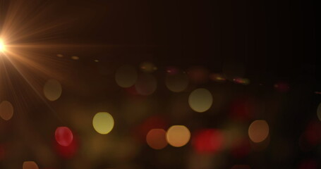 Poster - Shimmering colored light orbs shifting across dark backdrop at nighttime, lens flare