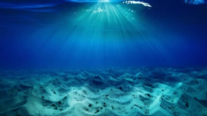 Poster - Underwater scene depicting sunrays piercing through turquoise water down to a sandy seabed creating a serene ambiance.