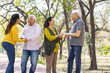 © G-images - Group of indian senior male and woman friends At park