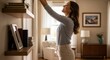 © Photo Moon - Woman Reaching for Book on Shelf in Cozy Home Living Room with Soft Lighting