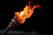 © Niken - Close up of burning torch light with copy space on black background