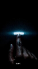 Poster - Finger touching a glowing start button in the dark