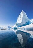 Beautiful view of a huge iceberg floating in the clear sea with copy space