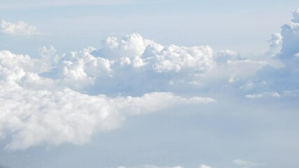 Wall Mural - blue sky with white fluffy clouds from airplane flight fly over the clouds in a sunny day with cloud moving in summer, summer cloudscape background