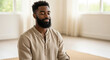 © Kevin - Calm bearded African American man meditating with eyes closed. Portrait of a serene Black male practicing mindfulness & yoga for stress relief, mental health, wellness and harmony.