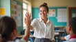 © Botakoz - Teacher smiling giving high five to student in classroom