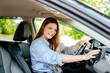 © wedmoments.stock - A confident young woman driving a car. Test-driving a new car or traveling.