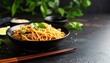 © ชัยธวัช ผาผง - Delicious Asian noodles garnished with fresh cilantro served in a black bowl with chopsticks on a dark surface surrounded by green plants creates a fresh ambiance.