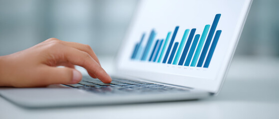 Poster - Person typing on laptop with colorful bar graph displayed on screen, indicating data analysis