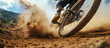 © Daniel - Mountain biking action, dust flying, close-up of tire, dynamic movement